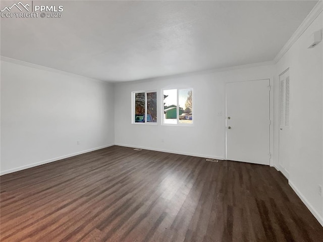 unfurnished room featuring dark hardwood / wood-style flooring and ornamental molding