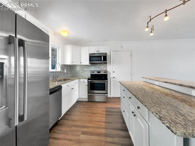 kitchen with sink, stainless steel appliances, white cabinets, and light stone counters