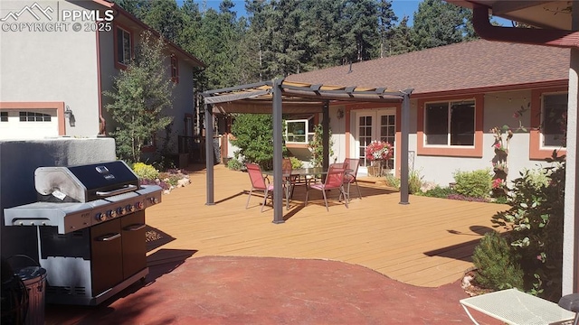 wooden terrace with outdoor dining area, area for grilling, and a pergola