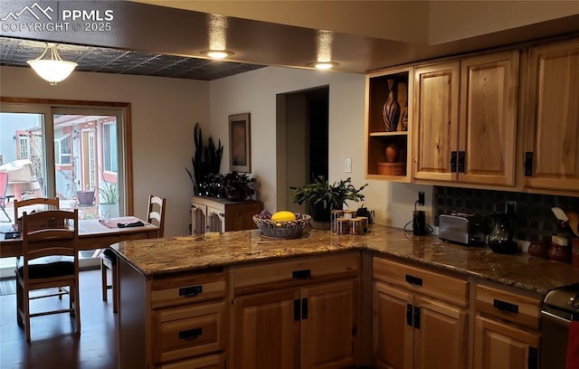 kitchen featuring light stone counters, a peninsula, dark wood-style floors, open shelves, and brown cabinetry