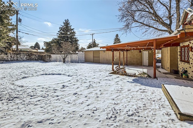 yard covered in snow with a storage shed