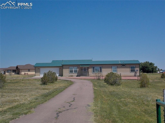 view of front of home featuring a garage and a front lawn