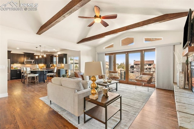 living room with ceiling fan, high vaulted ceiling, dark hardwood / wood-style flooring, and beamed ceiling