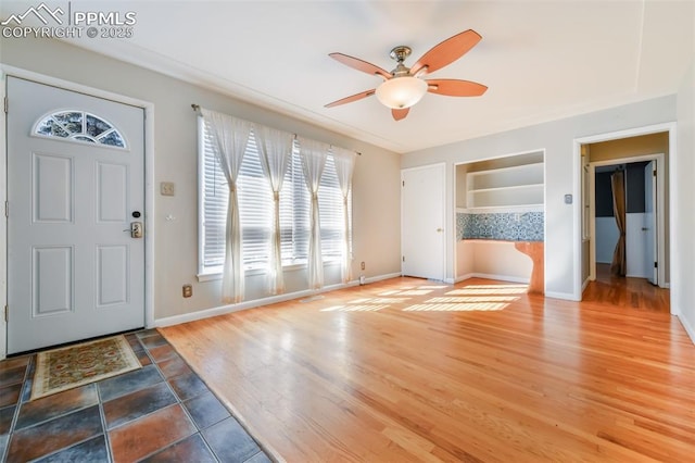 foyer entrance with wood-type flooring and ceiling fan