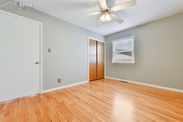 unfurnished bedroom with ceiling fan, a closet, and light hardwood / wood-style flooring