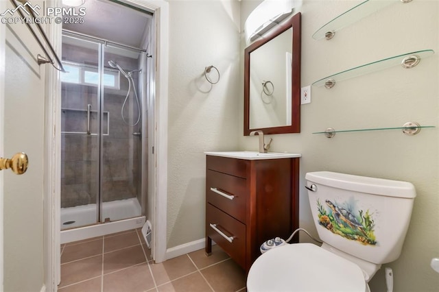 bathroom with vanity, toilet, a shower with shower door, and tile patterned flooring