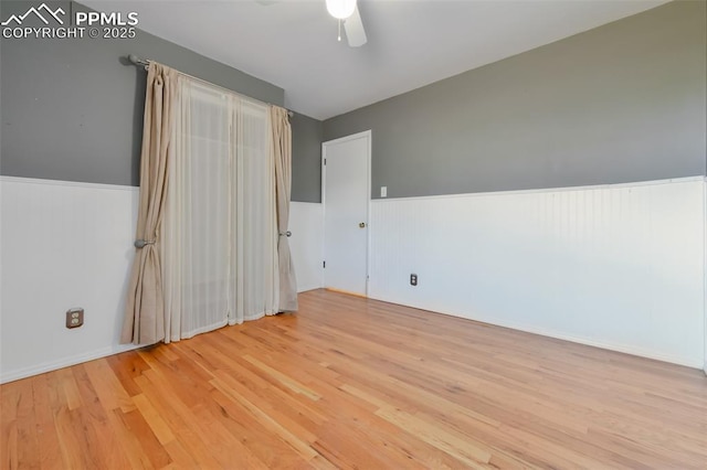 empty room featuring ceiling fan and light hardwood / wood-style floors