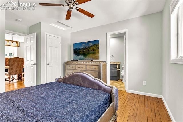 bedroom with ceiling fan, connected bathroom, and light hardwood / wood-style floors