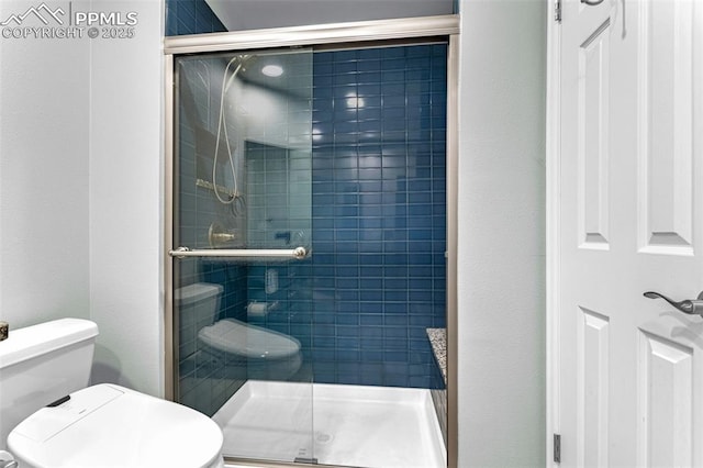 bathroom with an enclosed shower and toilet