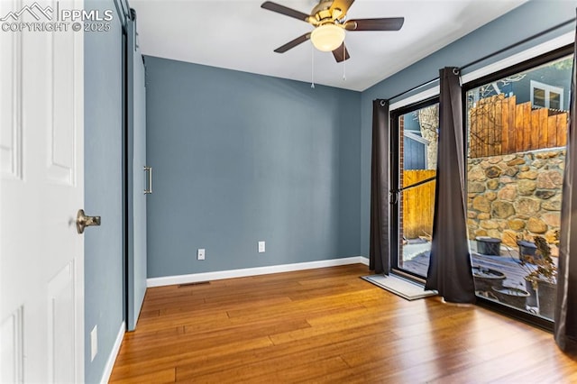 empty room featuring hardwood / wood-style flooring and ceiling fan