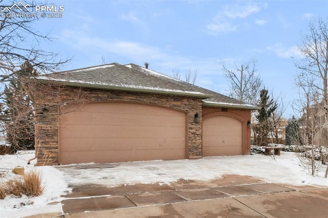 view of snow covered exterior with a garage