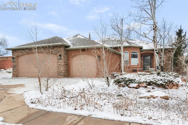 ranch-style home with an attached garage and stone siding