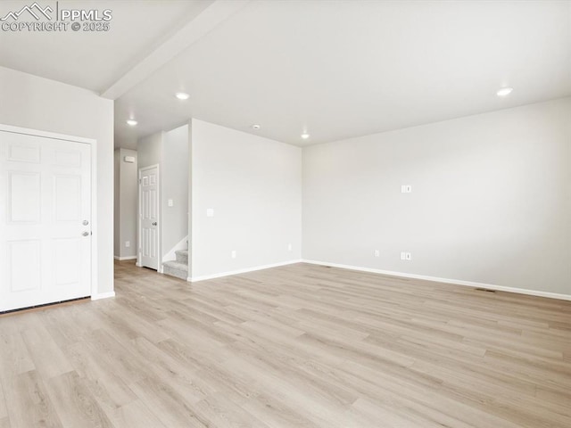 unfurnished room featuring stairway, recessed lighting, baseboards, and light wood finished floors