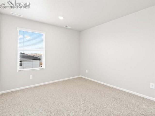 carpeted empty room featuring recessed lighting, visible vents, and baseboards