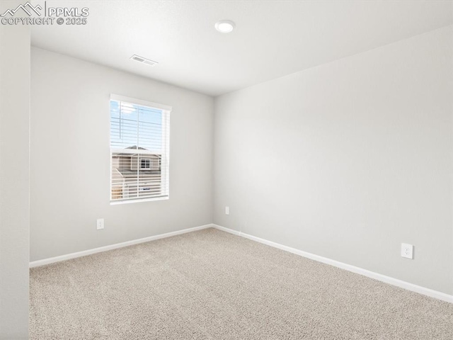 carpeted empty room with baseboards and visible vents