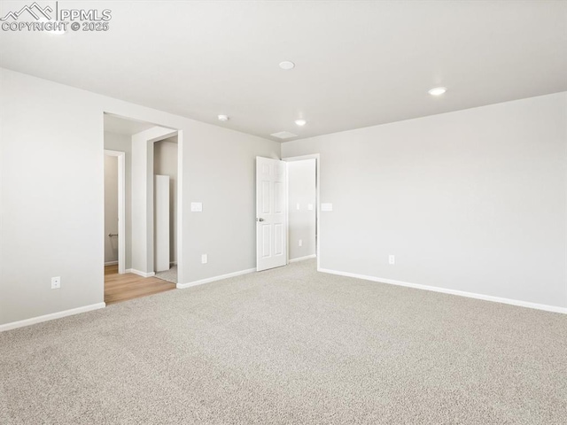 unfurnished bedroom with light carpet, recessed lighting, and baseboards