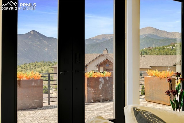 entryway featuring a mountain view and french doors