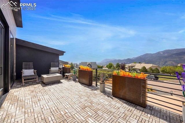 view of patio / terrace featuring a mountain view and a balcony