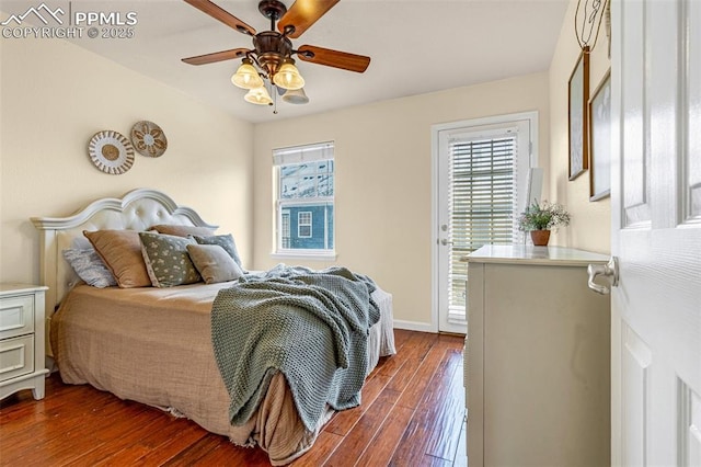 bedroom featuring dark wood-type flooring, ceiling fan, and access to outside