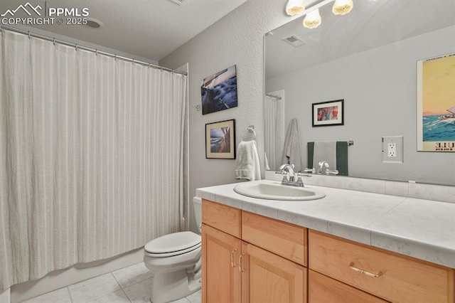 bathroom featuring visible vents, a textured wall, toilet, tile patterned flooring, and vanity