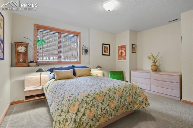 carpeted bedroom featuring visible vents, baseboards, and a textured ceiling