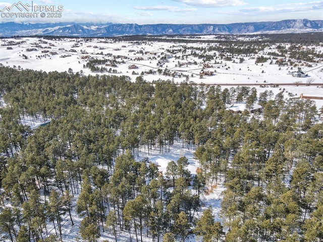 snowy aerial view with a mountain view