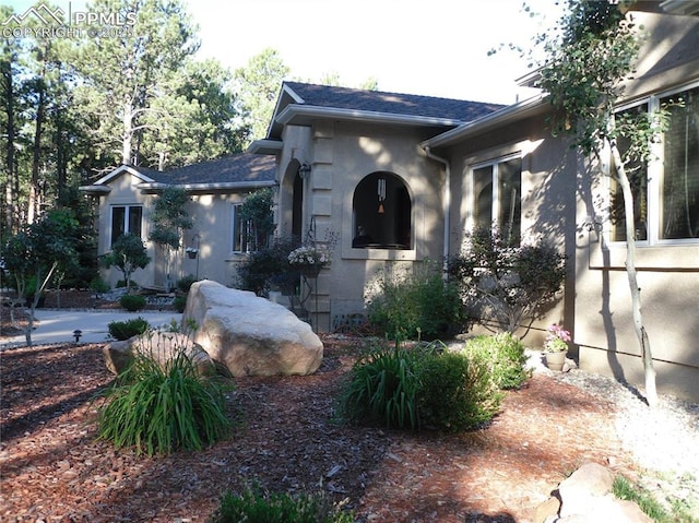 view of side of property featuring stucco siding