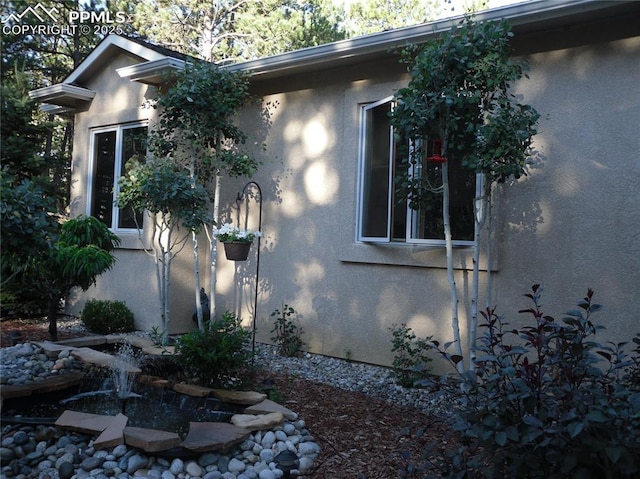 view of side of property with stucco siding