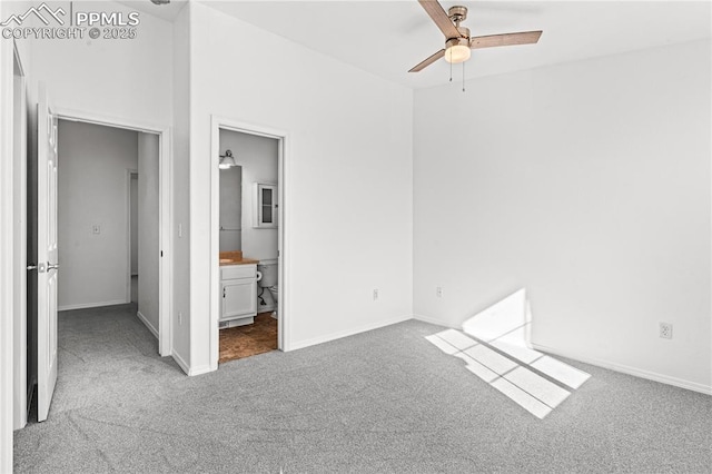 unfurnished bedroom featuring ceiling fan, light carpet, and ensuite bath