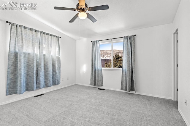 carpeted empty room featuring ceiling fan and lofted ceiling