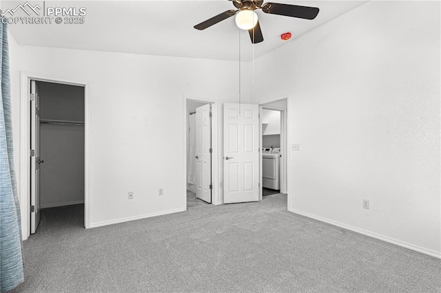 unfurnished bedroom with washer / dryer, a spacious closet, light carpet, and ceiling fan