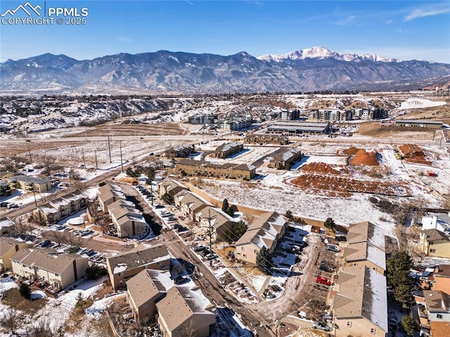 snowy aerial view with a mountain view