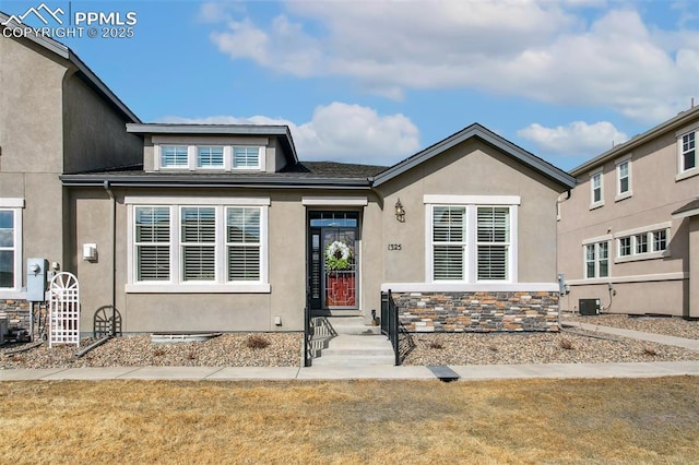 view of front of property featuring central AC and a front lawn