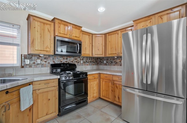 kitchen featuring ornamental molding, appliances with stainless steel finishes, light tile patterned flooring, and decorative backsplash