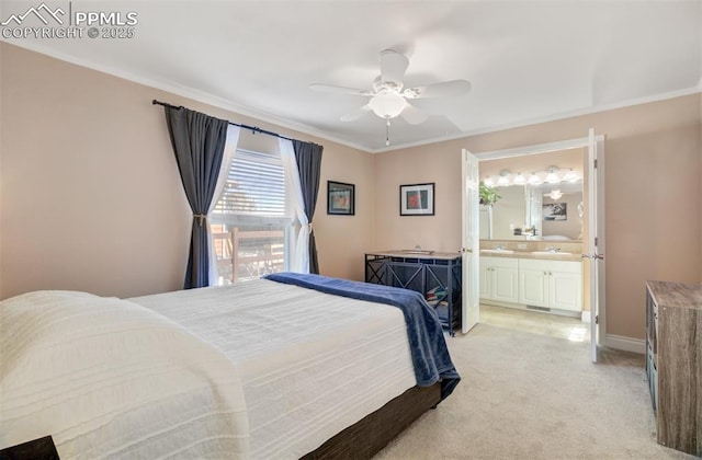 bedroom with ceiling fan, ensuite bathroom, light carpet, baseboards, and crown molding