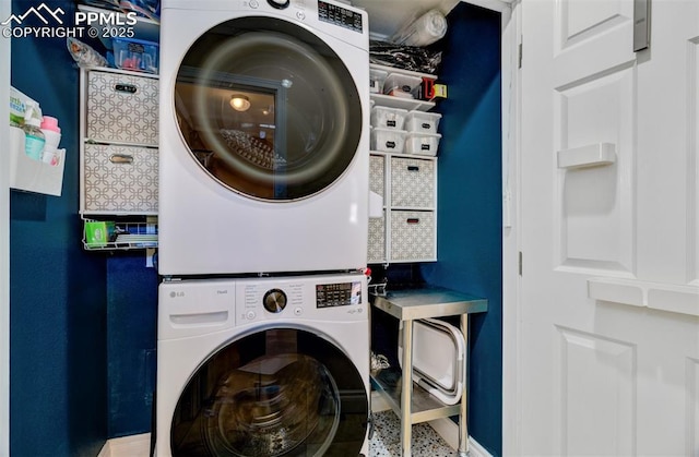 clothes washing area with stacked washer and dryer and laundry area