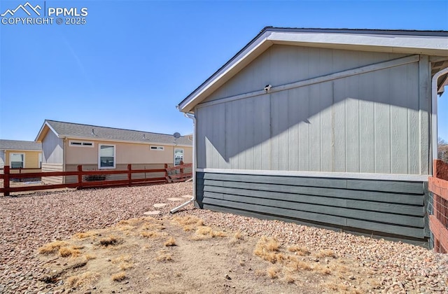 view of home's exterior with fence