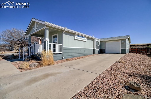 view of front of house featuring a garage, driveway, and a porch