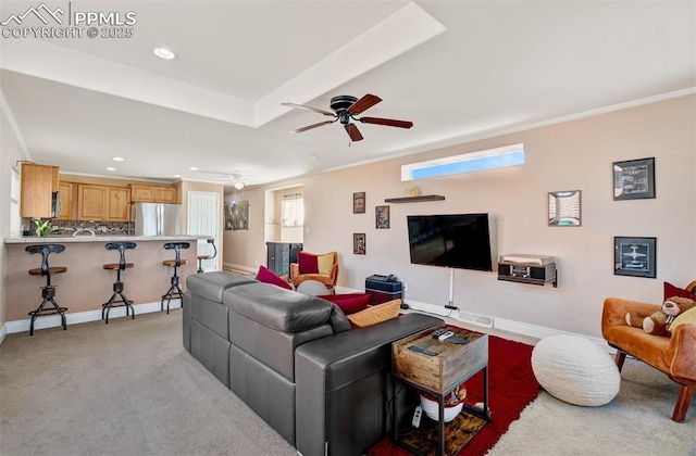 living area with light colored carpet, crown molding, and baseboards