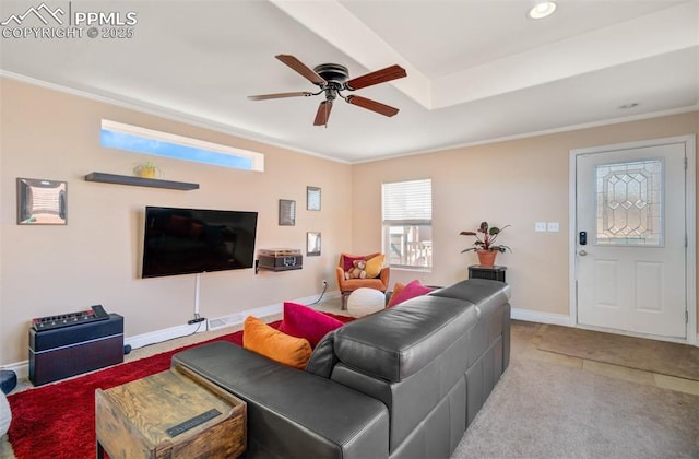 living room with carpet floors, crown molding, baseboards, and a ceiling fan