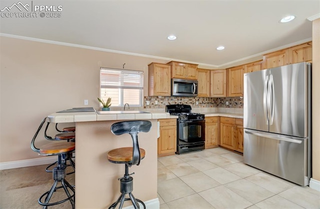 kitchen featuring a kitchen breakfast bar, light countertops, appliances with stainless steel finishes, decorative backsplash, and crown molding