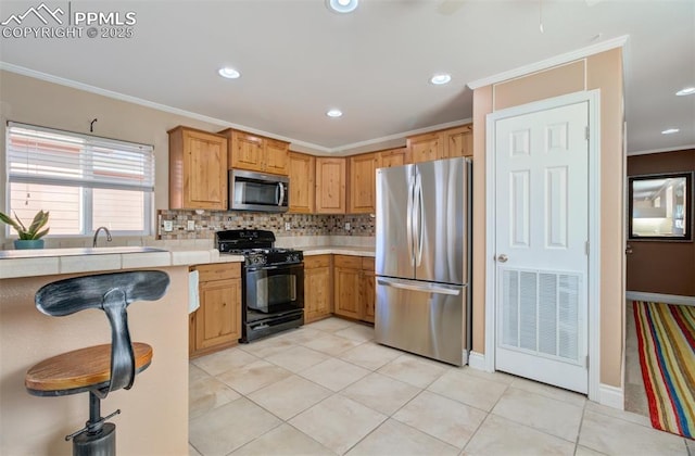 kitchen featuring light tile patterned floors, light countertops, appliances with stainless steel finishes, backsplash, and crown molding