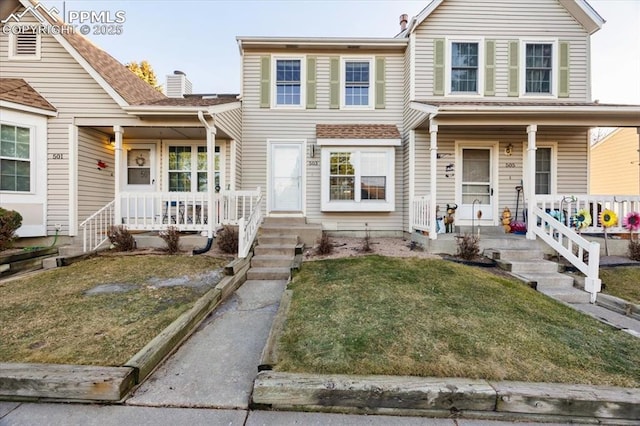 view of front of home with covered porch, central AC, and a front lawn