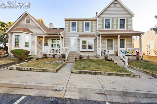 traditional-style home with a front lawn and a porch