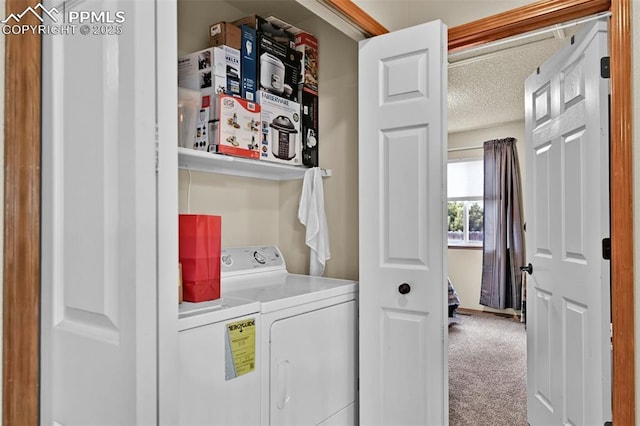 laundry room featuring independent washer and dryer, carpet, and a textured ceiling