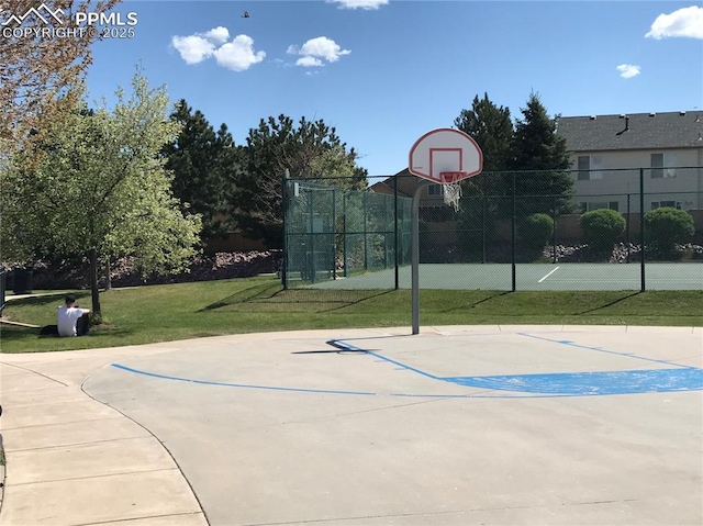 view of basketball court with a lawn