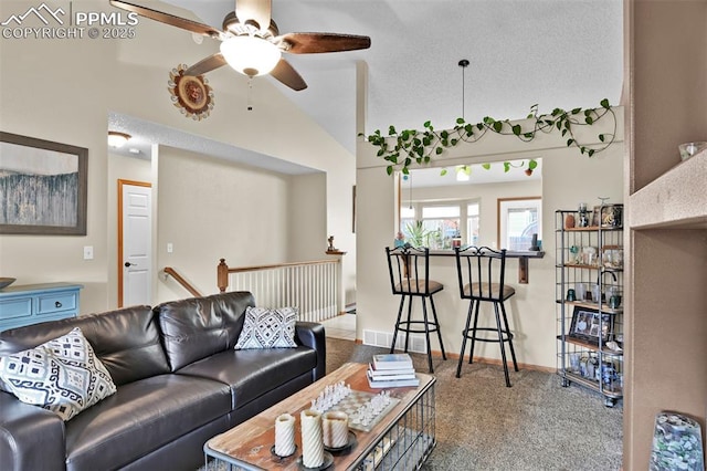 carpeted living room with a textured ceiling, vaulted ceiling, and ceiling fan