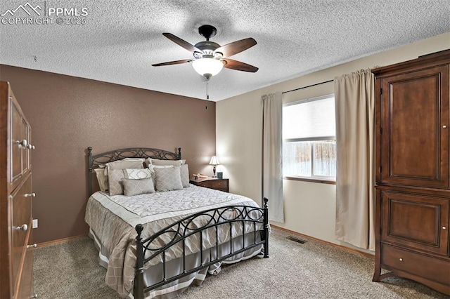 carpeted bedroom featuring a textured ceiling and ceiling fan