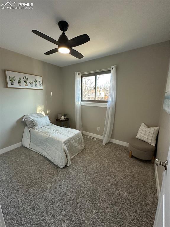 bedroom with ceiling fan, baseboards, and carpet flooring