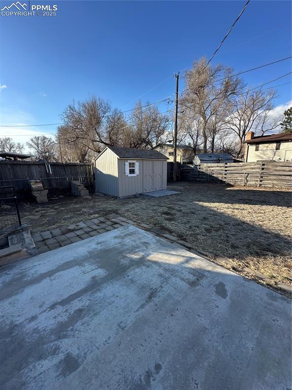 exterior space featuring an outbuilding, a patio area, and a fenced backyard